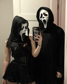 two people dressed up in costumes taking a selfie