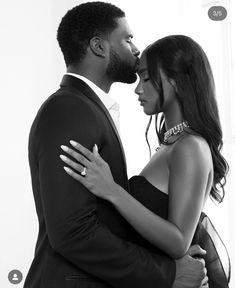 a black and white photo of a couple embracing