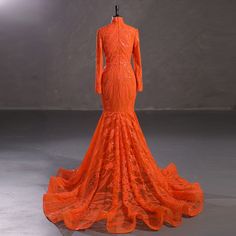 an orange wedding dress on display in a room