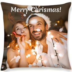 a man and woman are posing for a christmas photo with lights on the ground behind them