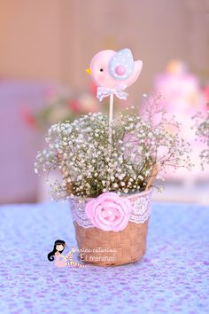 a small potted plant with baby's breath flowers and a bird on top