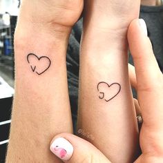 two people with matching tattoos on their arms