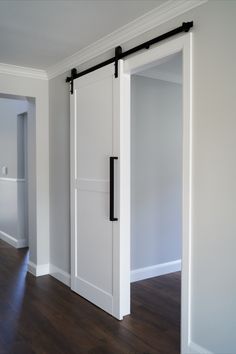 an empty room with white walls and sliding doors