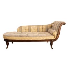 an old fashioned couch with wooden legs and upholstered fabric on the back, sitting in front of a white background