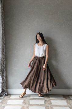 This linen maxi skirt with elastic waist is the perfect addition to any wardrobe. Crafted from high-quality linen, this long skirt is both comfortable and durable, ensuring that it will be a staple in your wardrobe for years to come. Featuring an elastic waist and two side functional pockets, the ABIGAIL linen skirt is designed for maximum comfort and ease of wear. The elastic band allows for a customizable fit, making it perfect for all body types. And with its long length, this linen skirt pro Brown Gathered Long Skirt, Brown Long Gathered Skirt, Brown Flowy Lined Maxi Skirt, Brown Gathered Flared Maxi Skirt, Brown Flowy Skirt, Brown Relaxed Full Maxi Skirt, Brown Flared Gathered Skirt Bottoms, Flowy Brown Skirt With Elastic Waistband, Brown Flared Gathered Skirt