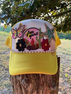 ❤️This is a yellow and white trucker hat  with 6 patches.  **The pins in the photo are just holding the patches. This hat hadn't been pressed yet so we can make adjustments for you if needed. The hat will be pressed when purchased. ** ❤️❤️ If you would like to order something custom please reach out to me before purchasing. We will discuss details and make your one of a kind hat something you will love. ❤️❤️ ❤️ Material: 100 % Polyester Hat Unique Patches ❤️Size: One Size Adult Hat  It is SnapBa White Patches Hat For Summer, Summer Gold Trucker Hat, Adjustable Gold Trucker Hat For Summer, Gold Adjustable Trucker Hat For Summer, Yellow Trucker Hat For Summer, Yellow Novelty Cap Style Hat, Trendy Yellow Baseball Cap For Summer, Yellow Novelty Cap, Trendy Yellow Snapback Hat