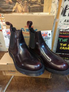 These are a more modern, yet still very nice pair of Made in England Dr Martens. They are the classic 2976 style Chelsea boot. A simple slip on boot with elasticated sides. The upper is a dark burgundy rub off leather. This is very neutral and easy to wear. They are a UK size 11, European 46,men's USA 12. Classic Chelsea Boots With Vibram Sole, Classic Slip-on Chelsea Boots With Vibram Sole, Classic Steel Toe Chelsea Boots, Dr Martens 2976, Styling Chelsea Boots, Dark Burgundy, Slip On Boots, Leather Boots Women, Mens Shoes Boots