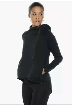 Nike Sportswear Tech Fleece Women's Asymmetrical Cape Jacket Style#: 669613-010 Black Size: XS The Nike Tech Fleece Women's Full-Zip Cape delivers soft, warm comfort for cooler weather. A staple to come from this season's collection, this makes for the perfect modern look. Completed with a full body zip and zipped pockets for keeping the essentials secure. Lightweight warmth Full zip placket Smooth soft feel Zip waist pockets Loose Fit drapes loosely on your body with generous room to let you mo Fall Sports Outerwear, Fall Sportswear For Sports, Nike Sports Outerwear With Ribbed Cuffs, Nike Urban Track Jacket For Gym, Nike Urban Outerwear For Gym, Modern Hooded Track Jacket For Winter, Casual Hooded Workout Jacket For Fall, Functional Fall Sports Sweatshirt, Casual Hooded Jacket For Fall Workouts