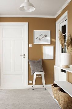 a room with a white door and brown walls