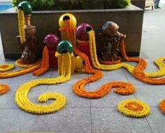 an arrangement of yellow and orange decorations on the ground