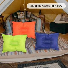 four pillows sitting on top of a bed in a tent