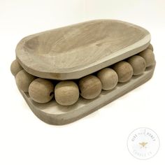 three wooden trays stacked on top of each other with balls in the middle and bottom