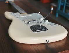 an electric guitar sitting on top of a wooden table