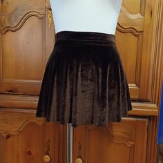 This pull on skirt is made from a chocolate brown stretch velvet.  Size medium fits waist 29-30.5 inches, hips 38.5-40 inches.  Front length 11.5.  Back length 13.5.  Free first class shipping within USA. Brown Stretch Party Skirt, Stretch Brown Skirt For Party, Brown Stretch Skirt For Party, Brown Stretch Mini Skirt, Brown Stretch Mini Skirt With Lining, Stretch Brown Mini Skirt For Fall, Brown Stretch Skirt, Brown Party Bottoms Short Length, Party Brown Short-length Bottoms