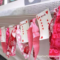 valentine's day paper hearts are hanging on the mantle