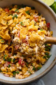 a bowl filled with macaroni and cheese, garnished with parsley