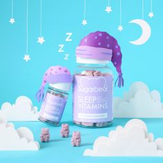 there are two jars with vitamins in them on the blue background and stars hanging from the ceiling