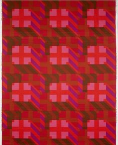 a red and purple rug with squares on it