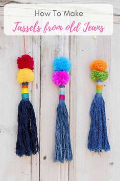 three colorful tassels hanging on the side of a wooden door