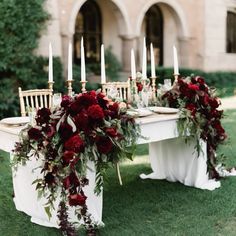 a table with flowers and candles on it