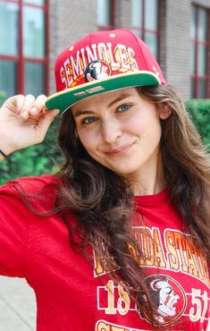 Get ready for the ultimate game day experience with The Seminoles "Blockbuster" Throwback Hat! This throwback snapback brings back the iconic Seminole logo in a retro, two-toned design. Perfect for any fan who wants to show off their team pride with a touch of nostalgia. Don't miss out on this must-have accessory for your game day ensemble! Details: *OFFICALLY LICENSED* High Profile, Structured Flat, Snapback 100% Brushed Cotton Twill Features Classic Seminole Logo, Embroidered Color: Vintage Garnet and Gold with Kelly Green under visor One Size Fits all Have questions about sizing, fit, or styling? Send us a chat or give us a call at 850-629-4890 during business hours 11AM - 5PM EST Monday-Friday! Tallahassee Florida, Garnet And Gold, Fashion Bottoms, Florida State University, Auburn Tigers, Color Vintage, Georgia Bulldogs, Alabama Crimson, Alabama Crimson Tide