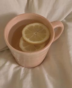 a cup filled with water and sliced lemons