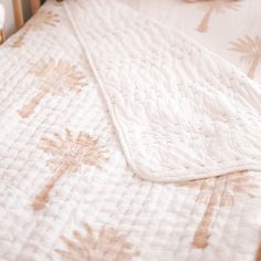 an unmade bed with white and brown bedspread