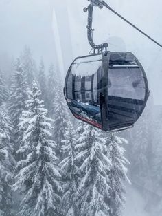 a ski lift with trees covered in snow