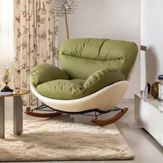 a living room with a green chair and white rugs on the floor in front of a window