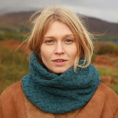 a woman with blonde hair wearing a blue scarf