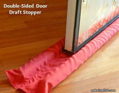 a pink umbrella sitting on top of a wooden floor next to an open door with the words double - sided door draft stopper