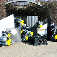 some black and white balloons are in the shape of cars