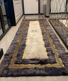 an area rug is on the floor in front of a door and some glass doors