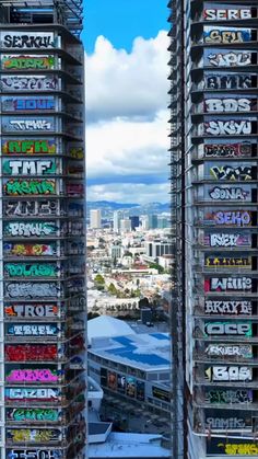 some very tall buildings with graffiti on them