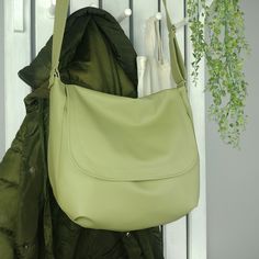 This large sling olive green messenger bag for women drow attention wherever you go. It looks great as vegan leather shoulder or crossbody purse and fits really well with any casual outfit. Great gift idea! One of the bags perfect for everyday use - durable, easy to pack and roomy. Lining with three pockets, one of them fastened with a zipper, extra handy zippered pocket back of the bag, 2 fasteners- zipper and magnetic closure on the flap. 100% handmade, fully vegan. DETAILS: color: olive green Green Satchel Saddle Bag With Adjustable Strap, Green Crossbody Saddle Bag For Everyday Use, Green Saddle Bag For Everyday Use, Green Saddle Bag With Adjustable Strap, Green Crossbody Saddle Bag With Adjustable Strap, Large Capacity Green Crossbody Hobo Bag, Green Soft Leather Crossbody Satchel, Green Satchel Saddle Bag For Everyday Use, Trendy Green Crossbody Hobo Bag