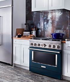 a stove top oven sitting inside of a kitchen