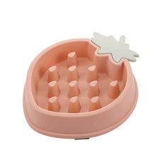 a pink bowl with an ice tray in the shape of a pineapple on top