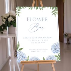 an easel with a flower bar sign on it