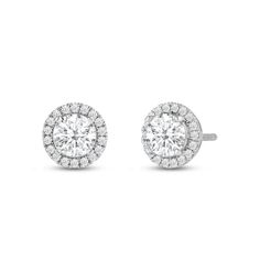 Classic round cut earrings with a stunning halo of round stones encircling the center stone.A lovely outfit-maker, this pair of stud earrings is what you need to give any ensemble a polished, put-together finish. Diamond Halo Earrings, Round Diamond Halo, Halo Diamond Earrings, Gorgeous Engagement Ring, Halo Earrings, Halo Setting, Moissanite Earrings, Bridal Bands, Stud Earrings For Women