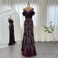 Luxury Burgundy Mermaid Design: The dress features a luxurious burgundy color in a flattering mermaid silhouette, exuding elegance and sophistication, making it an ideal choice for upscale events and special occasions. Long Formal Gown: With its long, flowing design, the dress captures a sense of elegance and refinement, ensuring you feel exquisite and refined for any wedding guest party or formal gathering. Elegant Arabic Style: Reflecting the grace of Arabic fashion, this dress seamlessly comb Burgundy Gown For Prom Banquet, Burgundy Evening Dress With Sweep Train, Burgundy Formal Gown With Sweep Train, Formal Burgundy Gown With Sweep Train, Purple Fishtail Formal Evening Dress, Burgundy Gown With Sweep Train For Formal Occasions, Burgundy Gown With Sweep Train For Formal Events, Burgundy Floor-length Evening Dress, Purple Floor-length Mermaid Dress With Sweep Train