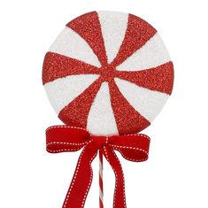 a red and white lollipop on a stick