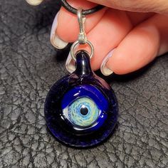 "Eyes have always been a fascination of mine. I make each handmade eye pendant using a blowtorch and Borosilicate glass in my studio. Some people refer to these eye pendants as Evil Eye Pendants. The evil eye has always been an ancient symbol that brings protection and good luck from any negative energy. I just like making eyes that look realistic, and glow from the silver in the glass. A lot goes into making these Evil Eye Pendants. First, I must create a murrini cane with the pupil and iris. I Heady Glass, Eye Pendant, Ancient Symbols, Evil Eye Pendant, Evil Eye Necklace, Glass Eyes, Jacksonville Fl, Eye Necklace, Necklace Handmade