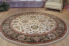 a living room with a large rug on the floor and a chair in front of it