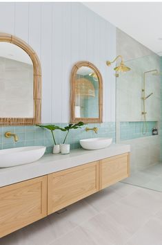 a bathroom with two sinks and mirrors in it