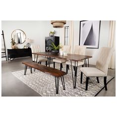 a dining room table with chairs and a bench in front of the table on top of a rug