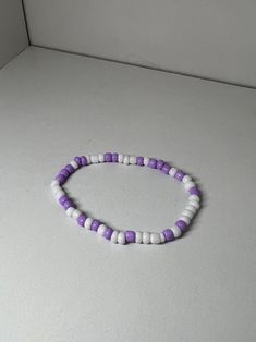 elastic lavender and white bracelet (know that when you order one it will always be different) Purple And White Beaded Bracelet, Casual Handmade White Friendship Bracelets, Casual White Handmade Friendship Bracelets, Casual Handmade White Friendship Bracelet, White Hypoallergenic Friendship Bracelets For Everyday, Adjustable Lavender Stretch Bracelet As Gift, Adjustable Purple Stretch Bracelet For Friendship, Flexible White Beaded Friendship Bracelet, Casual Purple Friendship Bracelets With Letter Beads