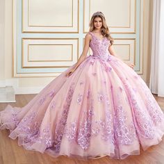 Celebrate in style in this extraordinary Quinceañera masterpiece. Crafted from sparkling glitter tulle and adorned with 3D floral embellishments, this showstopping ball gown ensures all eyes are on you. Featuring a stylish basque bodice adorned with sparkling sequins and shimmering beadwork, and a dramatic train edged in sleek horsehair, this one-of-a-kind gown sets the stage for a magical Quinceañera celebration. A matching capelet completes the showstopping style. Purple Quince Dress, Kids Pageant, Quinceañera Dresses, Crazy Dresses, Purple Things, Quince Dress, Prom Designs, Sweet 15, Fairytale Dress