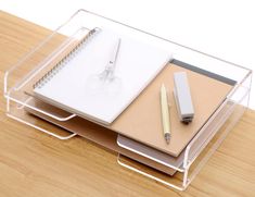 a desk with a pen and notebook on it