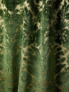 closeup of green and white fabric with floral design