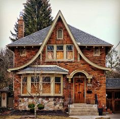 a red brick house with two story windows